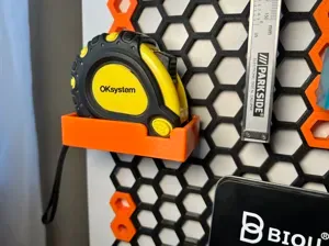 Honeycomb storage wall, holder for some generic tape measure