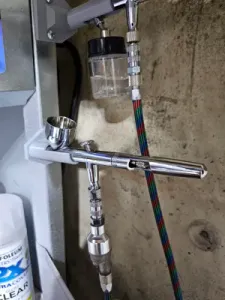 Iwata wall mounted airbrush stand. Gravity feed.