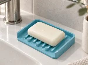 Self-draining soap dish with a sloped bottom