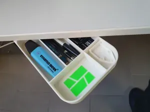 Swivelling under-desk pencil holder with drill-jig