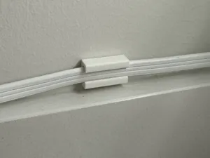 Power cable clips that use small command stips