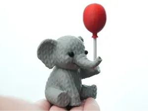 Knitted Elephant holding balloon