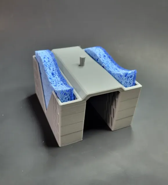 Sponge caddy for a split basin sink