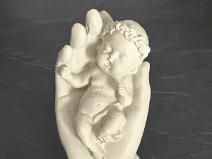 Hand Holding a Baby Symbol of Love and Protection