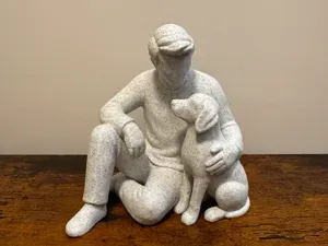 Gentle Moments: Man Sitting with Dog Sculpture