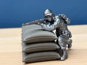 WWII Soldier Firing from Sandbags