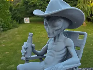 Alien in chair with beer and Hat