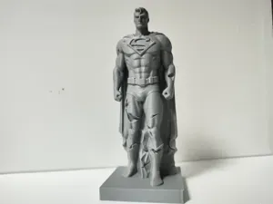 damaged standing stone sculpture of Superman