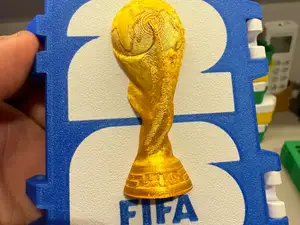 Caixa de Figurinha da copa com Taça no meio.