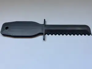 Mower Deck Scraper with Serrated Edge