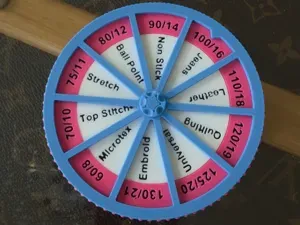 Needle reminder wheel