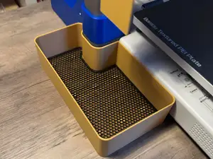 Fixable purge bucket for top-mount AMS & deflector