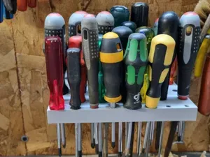 Screwdriver holder for wall mount in workshop.