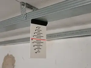 Magnetic laser target for drywall profiles