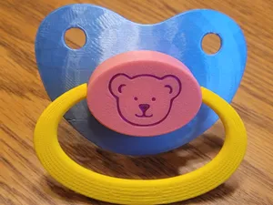 Adult size pacifier parts.