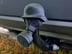 Gas mask with helmet hitch ball cover