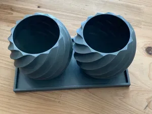 Twisted planters with base and circular plates.