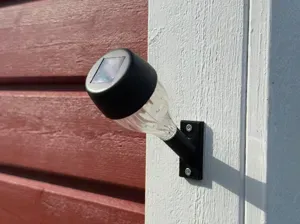 Wall holder for small solar garden lamp