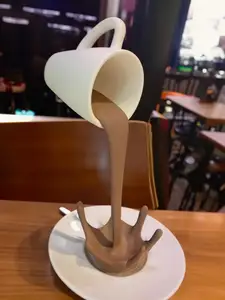 Floating coffee cup sculpture