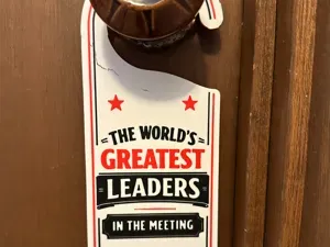 World's greatest leader in the meeting door sign
