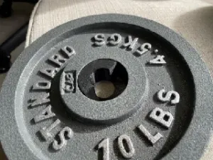Dumbbell adapter. Two inch weight on one inch bar