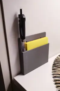 Stand on the wall for a pad with a pen.