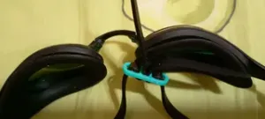 The bracket for securing the strap of swimming goggles.