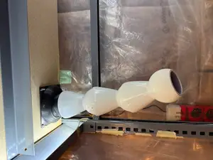 Exhaust air duct venting from enclosed shelving to outside