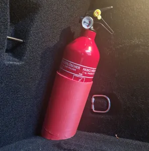 Fire extinguisher holder for the trunk of a car