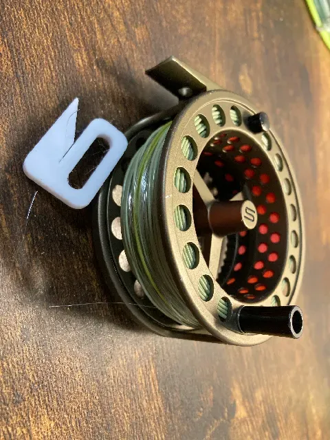 Fishing line stopper for fly reel