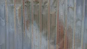 Battered sheet metal wall