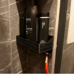 Bathroom shelf with a razor holder