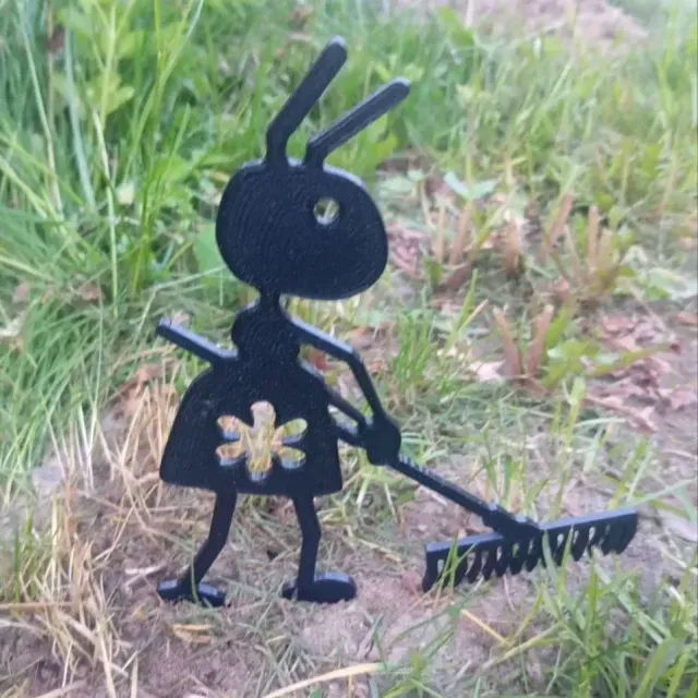 Garden figure of an ant with a rake