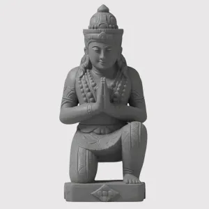 Statue of an Eastern deity in prayer.