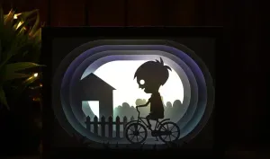 Boy Riding Bicycle lightbox (shadow box)