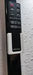 Wall mounted soundbar remote control holder.