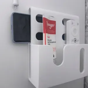 wall-mounted remote control and phone holder
