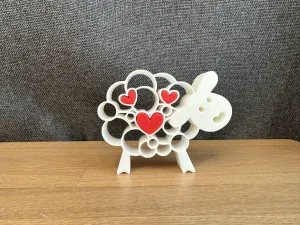 Sheep figurine with hearts
