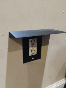Square outlet cover with shelf