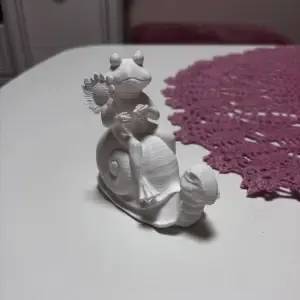 snail riding a frog garden decoration