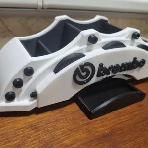 A desk organizer shaped like a brake caliper